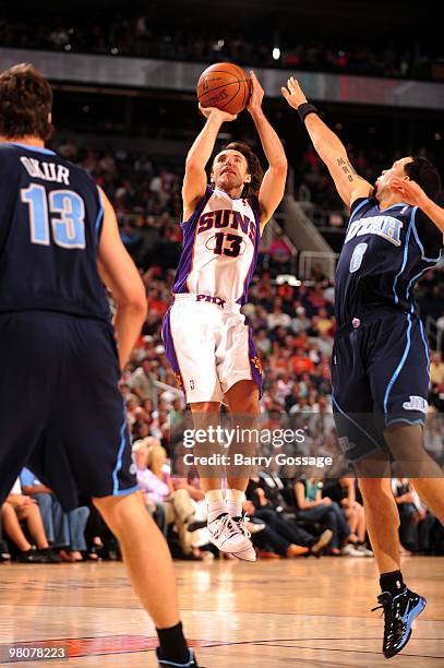 Steve Nash of the Phoenix Suns shoots a jump shot against Mehmet Okur and Deron Williams of the Utah Jazz during the game at U.S. Airways Center on...