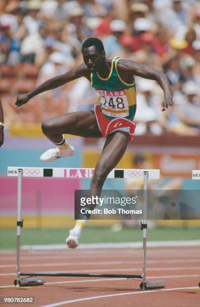 Amadou Dia Ba of Senegal competes in heat 5 of round one of the Men's 400 metres hurdles event inside the Memorial Coliseum at the 1984 Summer...