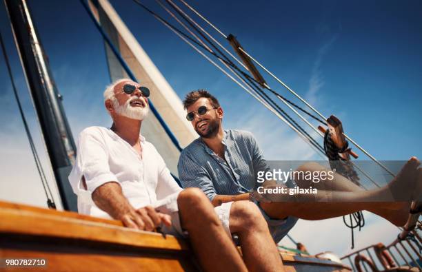 father and son sailing. - rich sailing imagens e fotografias de stock