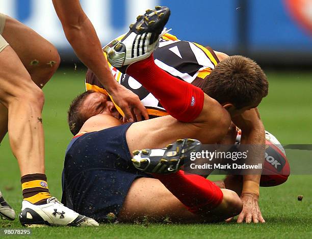 Brad Green of the Demons is tackled by Jarrod Kayler-Thomson of the Hawks during the round one AFL match between the Melbourne Demons and the...