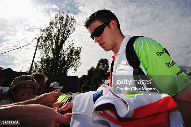 Paul Di Resta of Great Britain and Force India signs autographs for fans before qualifying for the Australian Formula One Grand Prix at the Albert...