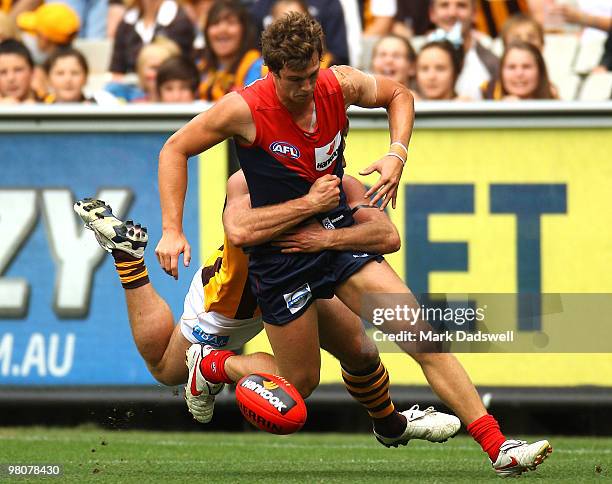 James Strauss of the Demons is tackled by Campbell Brown of the Hawks during the round one AFL match between the Melbourne Demons and the Hawthorn...