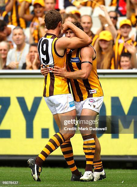 Jarryd Morton congratulates Campbell Brown of the Hawks during the round one AFL match between the Melbourne Demons and the Hawthorn Hawks at...