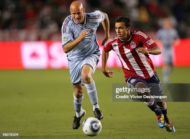 Jonathan Bornstein of Chivas USA paces the ball on defense under pressure from Conor Casey of the Colorado Rapids in the first half during their MLS...