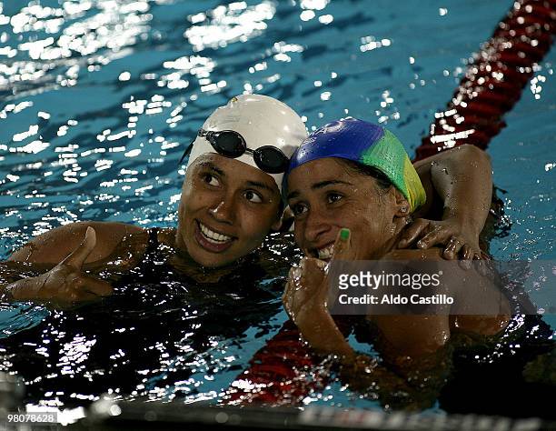 Paula Daynara of Brazil , winner of gold medal and Carolina Colorado of Colombia, winner of silver medal celebrate victory during the 100 meter...