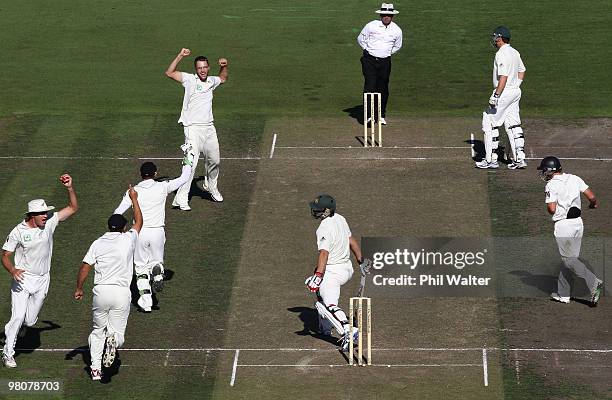 Daniel Vettori of New Zealand celebrates the catch of Tim McIntosh of New Zealand to dismiss Mitchell Johnson of Australia during day one of the...