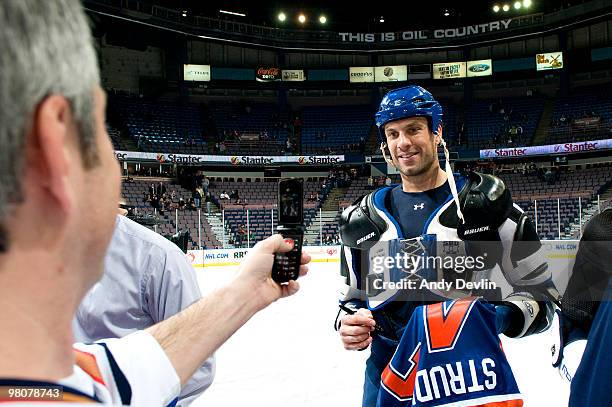 Jason Strudwick of the Edmonton Oilers poses for a fan photo during "Shirts off our Backs" promotion after a game against the Anaheim Ducks at Rexall...