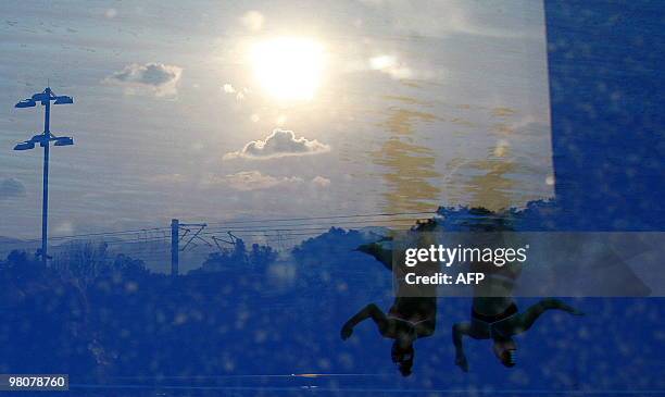 Uruguayans Sofia Orihuela and Florencia Rodrigo practice before a performs in women's synchronised swimming duet technical routine during the IX...