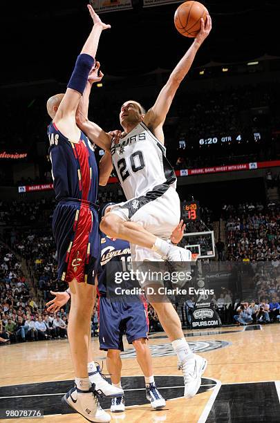 Manu Ginobili of the San Antonio Spurs shoots against Zydrunas Ilgauskas of the Cleveland Cavaliers on March 26, 2010 at the AT&T Center in San...