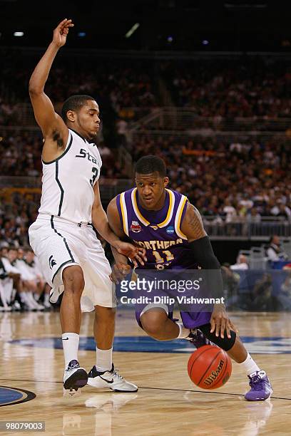 Kwadzo Ahelegbe of the Northern Iowa Panthers drives past Chris Allen of the Michigan State Spartans during the midwest regional semifinal of the...