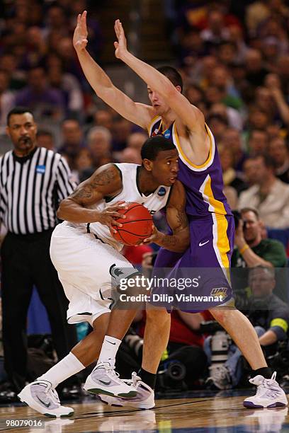 Korie Lucious of the Michigan State Spartans looks to get past Adam Koch of the Northern Iowa Panthers during the midwest regional semifinal of the...