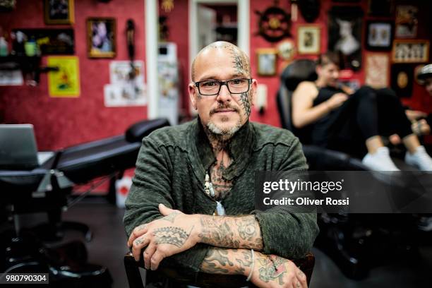 portrait of tattooist sitting in his studio - name tattoos stock pictures, royalty-free photos & images