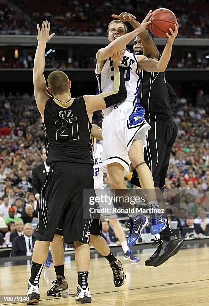 Guard Jon Scheyer of the Duke Blue Devils takes a shot against D.J. Byrd of the Purdue Boilermakers during the south regional semifinal of the 2010...