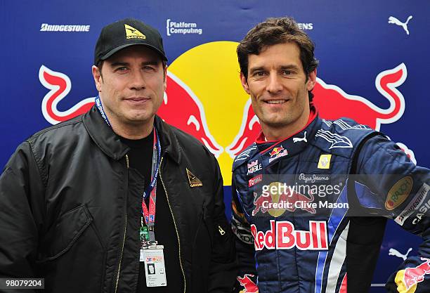 Mark Webber of Australia and Red Bull Racing meets actor John Travolta before qualifying for the Australian Formula One Grand Prix at the Albert Park...