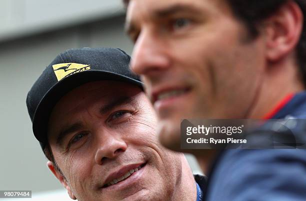 Mark Webber of Australia and Red Bull Racing meets actor John Travolta before qualifying for the Australian Formula One Grand Prix at the Albert Park...