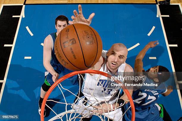 Marcin Gortat of the Orlando Magic shoots against Corey Brewer of the Minnesota Timberwolves during the game on March 26, 2010 at Amway Arena in...