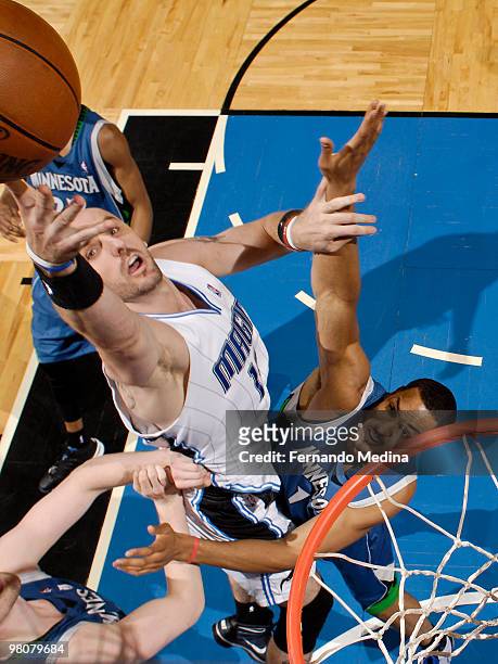 Marcin Gortat of the Orlando Magic shoots against Ryan Hollins of the Minnesota Timberwolves during the game on March 26, 2010 at Amway Arena in...