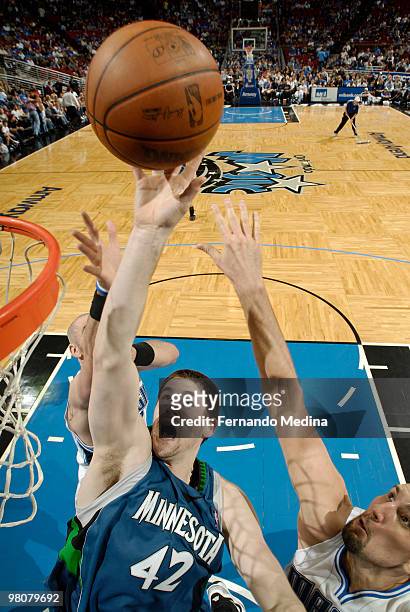 Kevin Love of the Minnesota Timberwolves puts back an offensive rebound against Ryan Anderson of the Orlando Magic during the game on March 26, 2010...