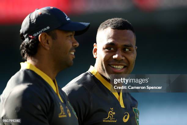 Samu Kerevi of the Wallabies talks to team mate Kurtley Beale during the Australian Wallabies captain's run at Allianz Stadium on June 22, 2018 in...