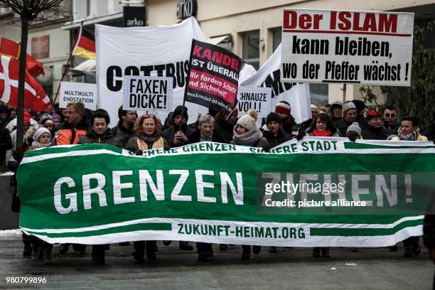 Participants hold banners and flags as they take part in an anti-refugee demonstration orginized by the group 'Zukunft Heimat', in Cottbus, Germany,...