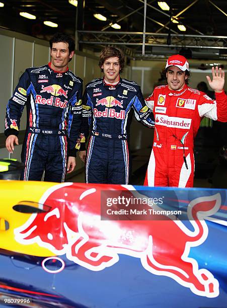 Pole sitter Sebastian Vettel of Germany and Red Bull Racing celebrates in parc ferme alongside second placed Mark Webber of Australia and Red Bull...