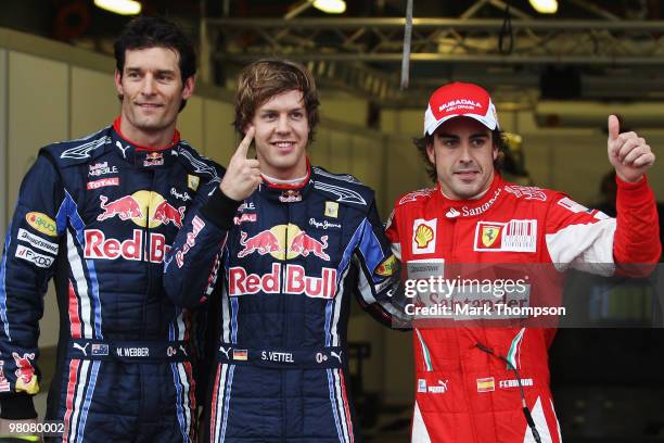 Pole sitter Sebastian Vettel of Germany and Red Bull Racing celebrates in parc ferme alongside second placed Mark Webber of Australia and Red Bull...