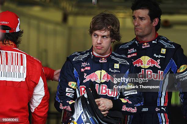 Pole sitter Sebastian Vettel of Germany and Red Bull Racing is seen in parc ferme alongside second placed Mark Webber of Australia and Red Bull...