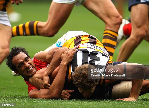 Campbell Brown of the Hawks tackles Jamie Bennell of the Demons during the round one AFL match between the Melbourne Demons and the Hawthorn Hawks at...