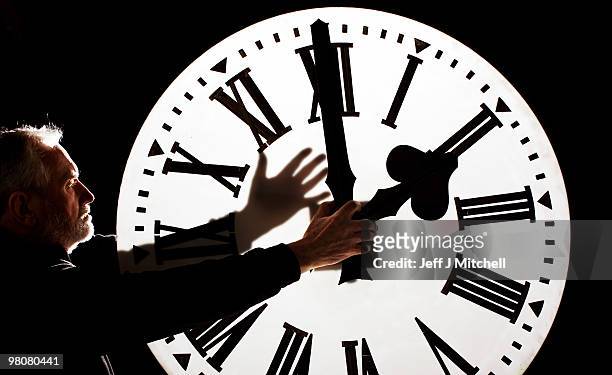 Alan Wilson, Director of James Ritchie & Son clockmakers, founded in 1809, adjusts a clock face to British Summer Time on March 26, 2010 in...
