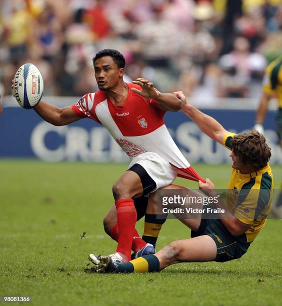 Feleti Fifita of Tonga is tackled by Liam Gill of Australia on day two of the IRB Hong Kong Sevens on March 27, 2010 in Hong Kong.
