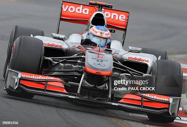 Reigning World Champion Jensen Button of Britain powers through a corner during qualifying for Formula One's Australian Grand Prix in Melboune on...