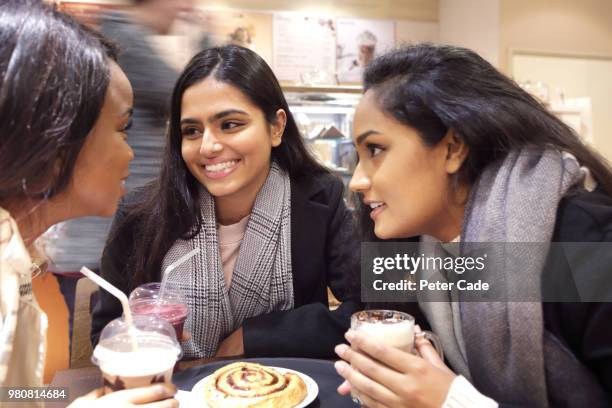 three friends at table talking in coffee shop - whispering stock pictures, royalty-free photos & images