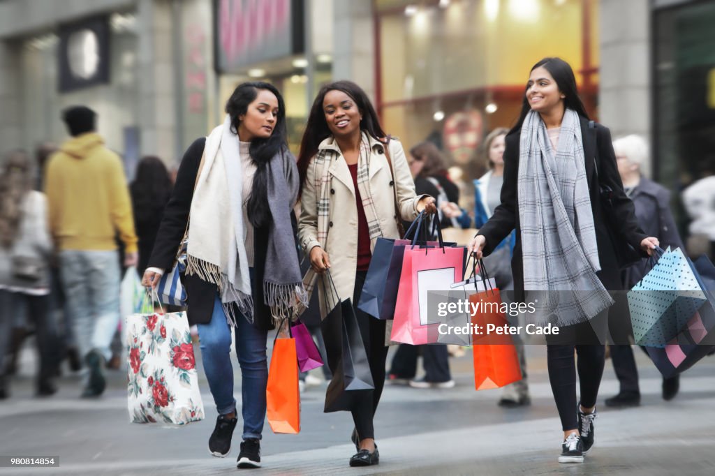 Three young women in town shopping