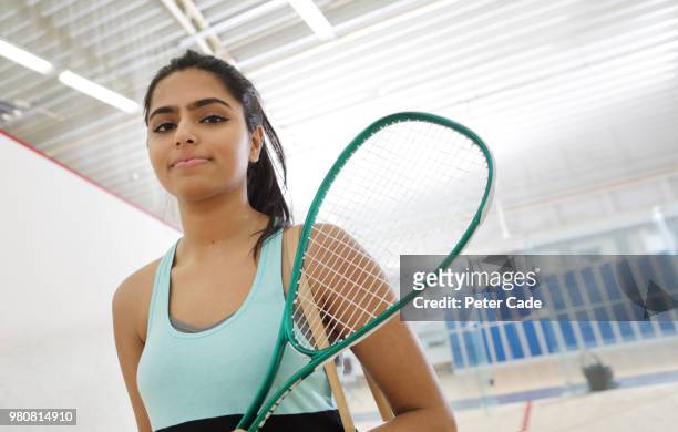 Young woman going to play squash