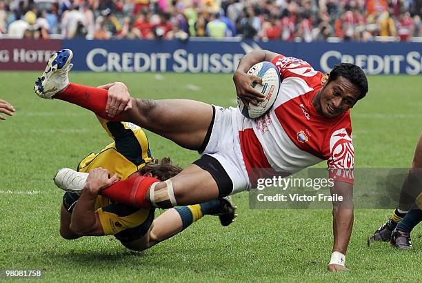 Jack Ram of Tonga is tackled by Liam Gill of Australia on day two of the IRB Hong Kong Sevens on March 27, 2010 in Hong Kong.