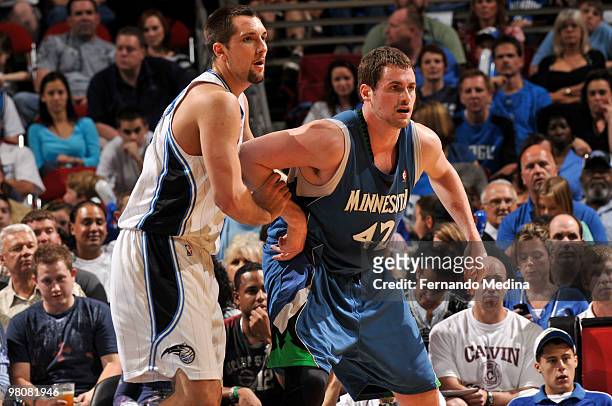 Ryan Anderson of the Orlando Magic bodies up against Kevin Love of the Minnesota Timberwolves during the game on March 26, 2010 at Amway Arena in...