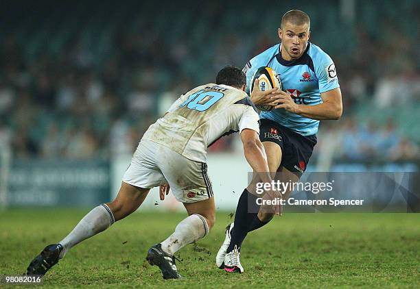 Drew Mitchell of the Waratahs runs the ball during the round seven Super 14 match between the Waratahs and the Blues at Sydney Football Stadium on...