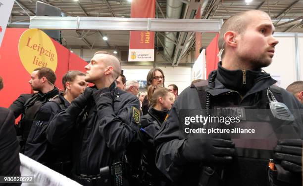 March 2018, Germany, Leipzig: Police officers secure a discussion group from a right-winged publisher at the Leipzig Book Fair. Photo: Sebastian...