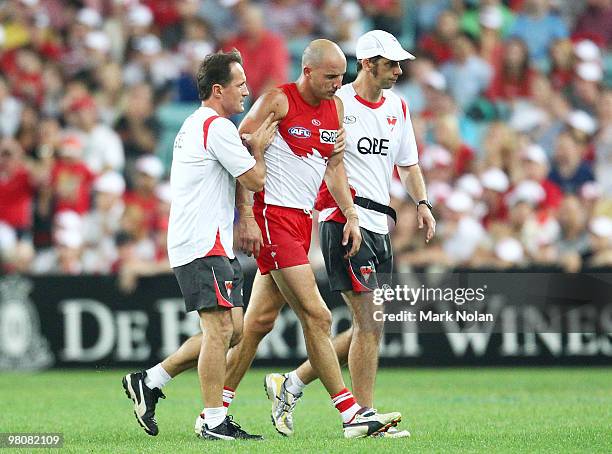 Tadhg Kennelly of the Swans is taken from the field after being concussed by Zac Dawson of the Saints during the round one AFL match between the...