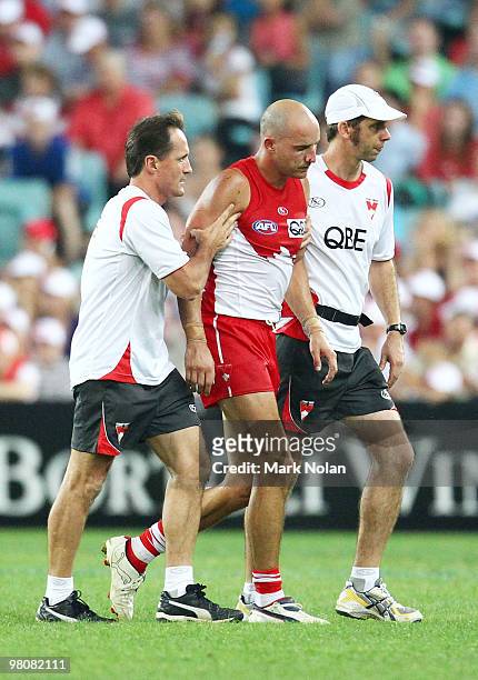 Tadhg Kennelly of the Swans is taken from the field after being concussed by Zac Dawson of the Saints during the round one AFL match between the...