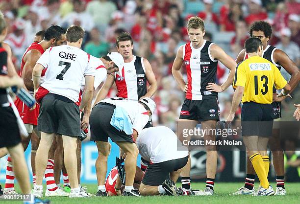Tadhg Kennelly of the Swans is taken from the field after being concussed by Zac Dawson of the Saints during the round one AFL match between the...