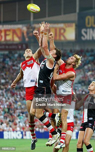 Mark Seaby of the Swans, Justin Koschitzke of the Saints and Lewis Roberts-Thomson of the Swans contest a mark during the round one AFL match between...