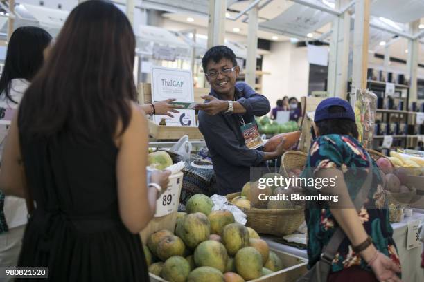 Vendor serves customers at a fruit stall in the CentralWorld shopping mall, operated by Central Pattana Pcl , in Bangkok, Thailand, on Saturday, June...