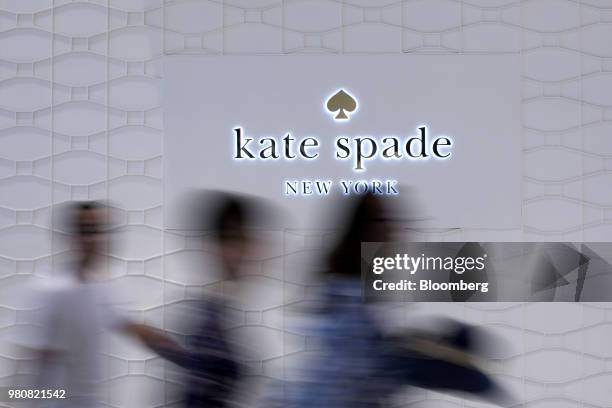 People walk past signage for a Kate Spade & Co. Store at CentralWorld shopping mall, operated by Central Pattana Pcl , in Bangkok, Thailand, on...