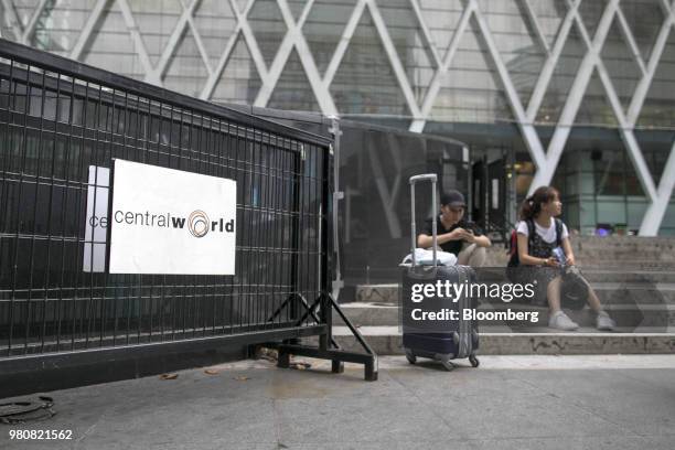 Tourists sit outside the CentralWorld shopping mall, operated by Central Pattana Pcl , in Bangkok, Thailand, on Saturday, June 16, 2018. Growth in...