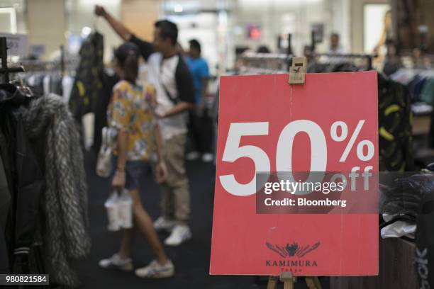 Discount sign reading "50% Off" for the Tokyo Kamimura brand is displayed at the CentralWorld shopping mall, operated by Central Pattana Pcl , in...