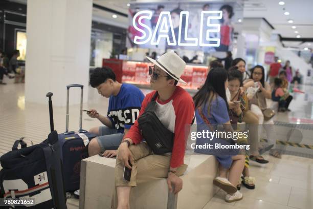 Shoppers sit inside the CentralWorld shopping mall, operated by Central Pattana Pcl , in Bangkok, Thailand, on Saturday, June 16, 2018. Growth in...