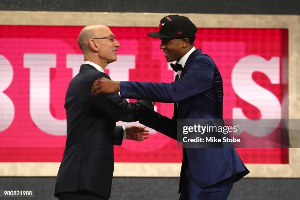 Chandler Hutchison poses with NBA Commissioner Adam Silver after being drafted 22nd overall by the Chicago Bulls during the 2018 NBA Draft at the...