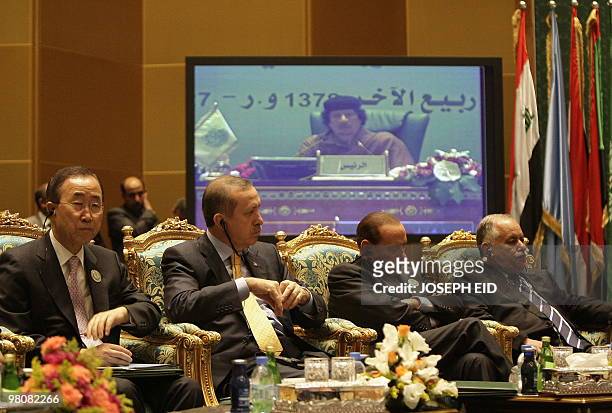 Video screen showing Libyan Leader Moamer Qadhafi is seen above UN Secretary General Ban Ki Moon, Turkish PM Recep Tayyip Erdogan, Italian PM Silvio...