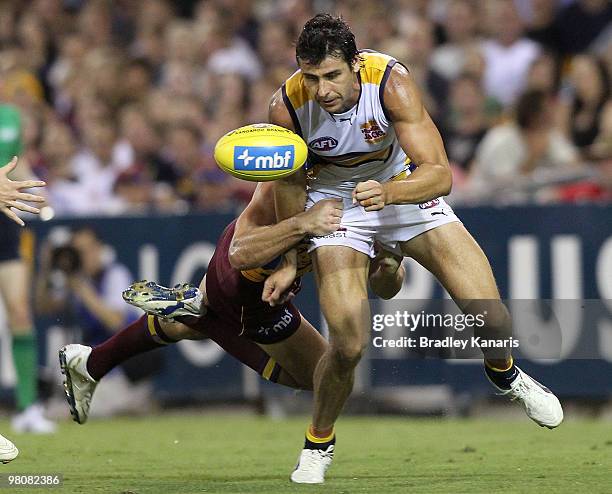 Andrew Embley of the Eagles gets a hand ball away during the round one AFL match between the Brisbane Lions and the West Coast Eagles at The Gabba on...